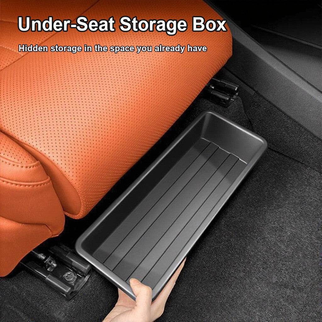 Black under-seat storage box being slid into the space below a car seat