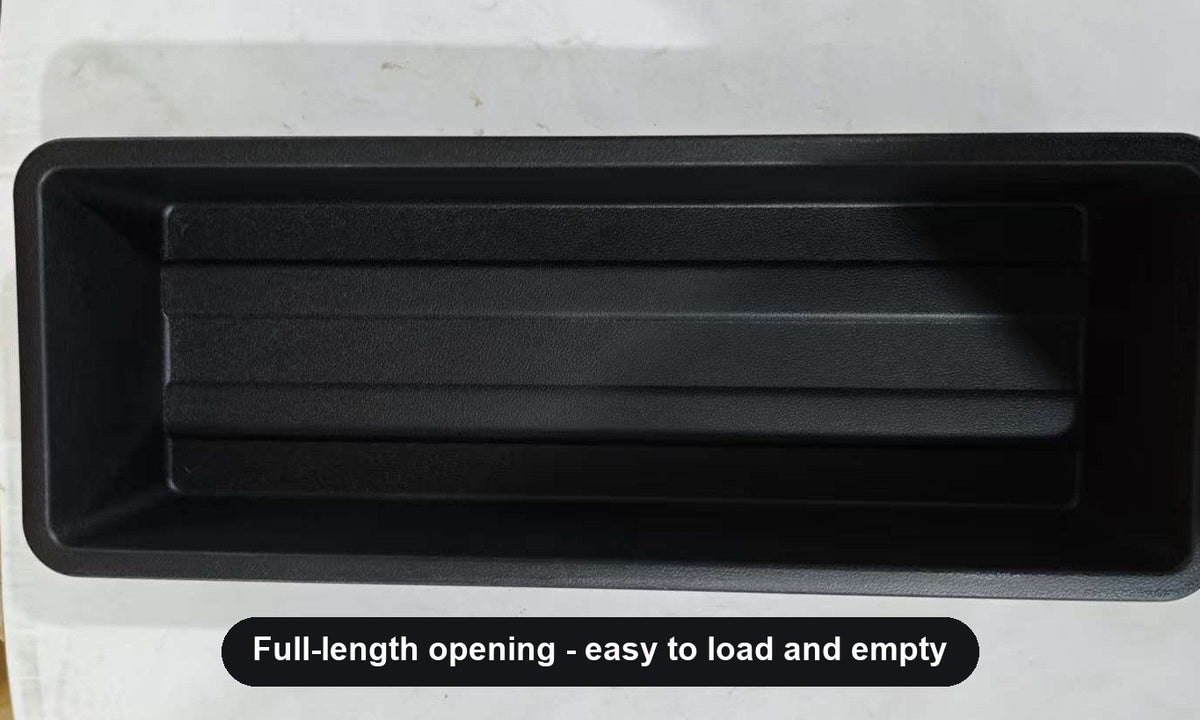 Top view of the open under-seat storage tray and its full-length opening