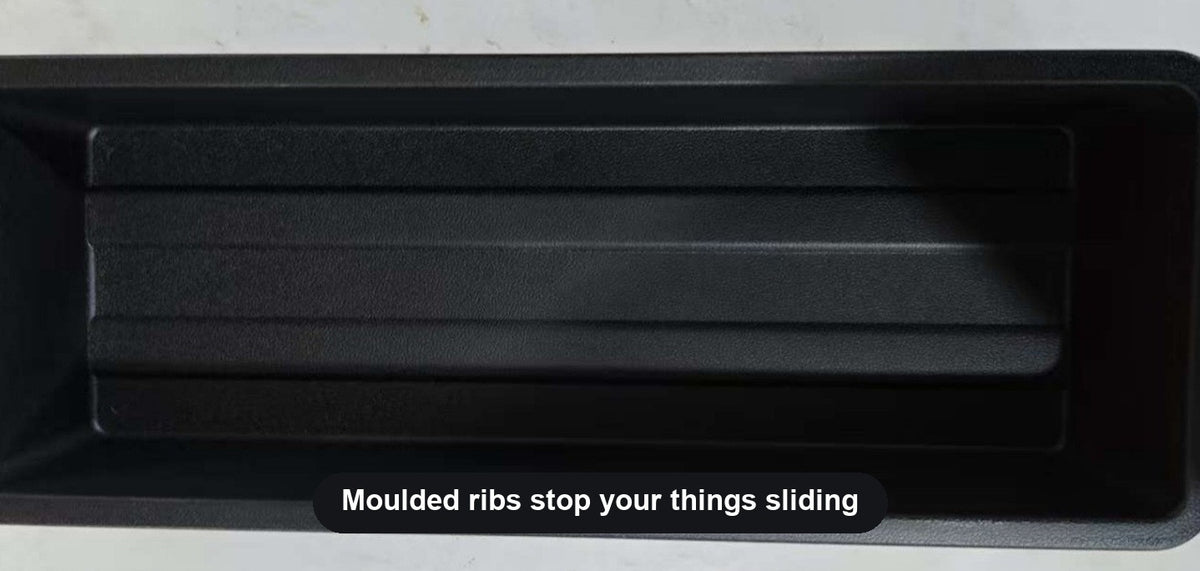 Ribbed floor of the under-seat storage tray stops items sliding