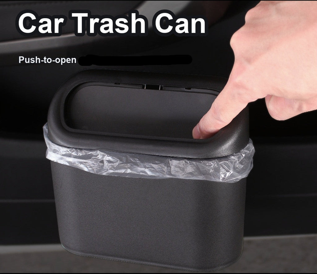 Black car trash can hanging on the car door with a bin liner, press-to-open lid